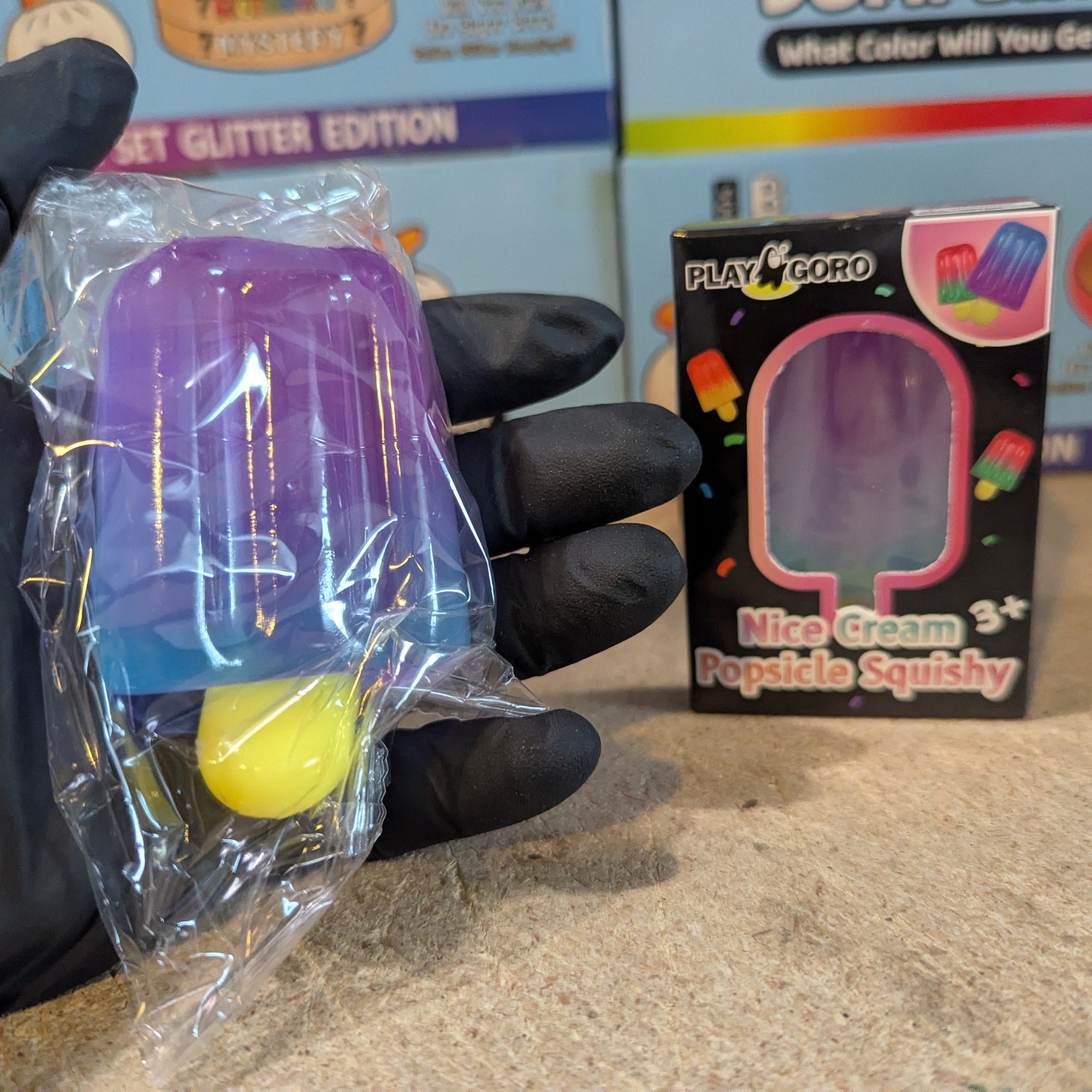 Purple to blue gelatin ice cream popsicle squish toy from Ralphie's Funhouse, soft and squeezable with colorful design.