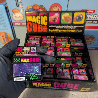 Purple translucent glitter mini magic cube by Squeeze Toys, slow-rising squish toy with sparkly glitter finish.