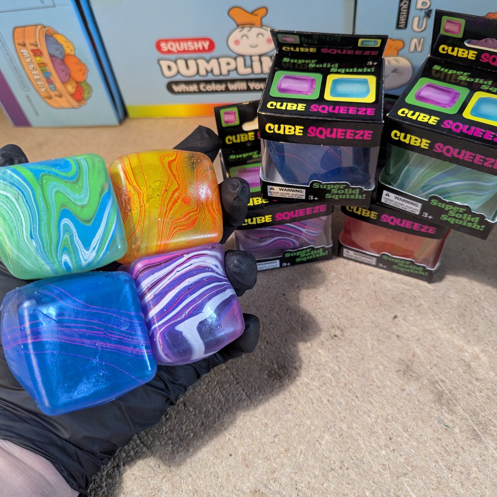 Set of four Ralphie's Funhouse Versus Swirl Squeeze Cubes, slow-rising squish toys in vibrant swirl designs.