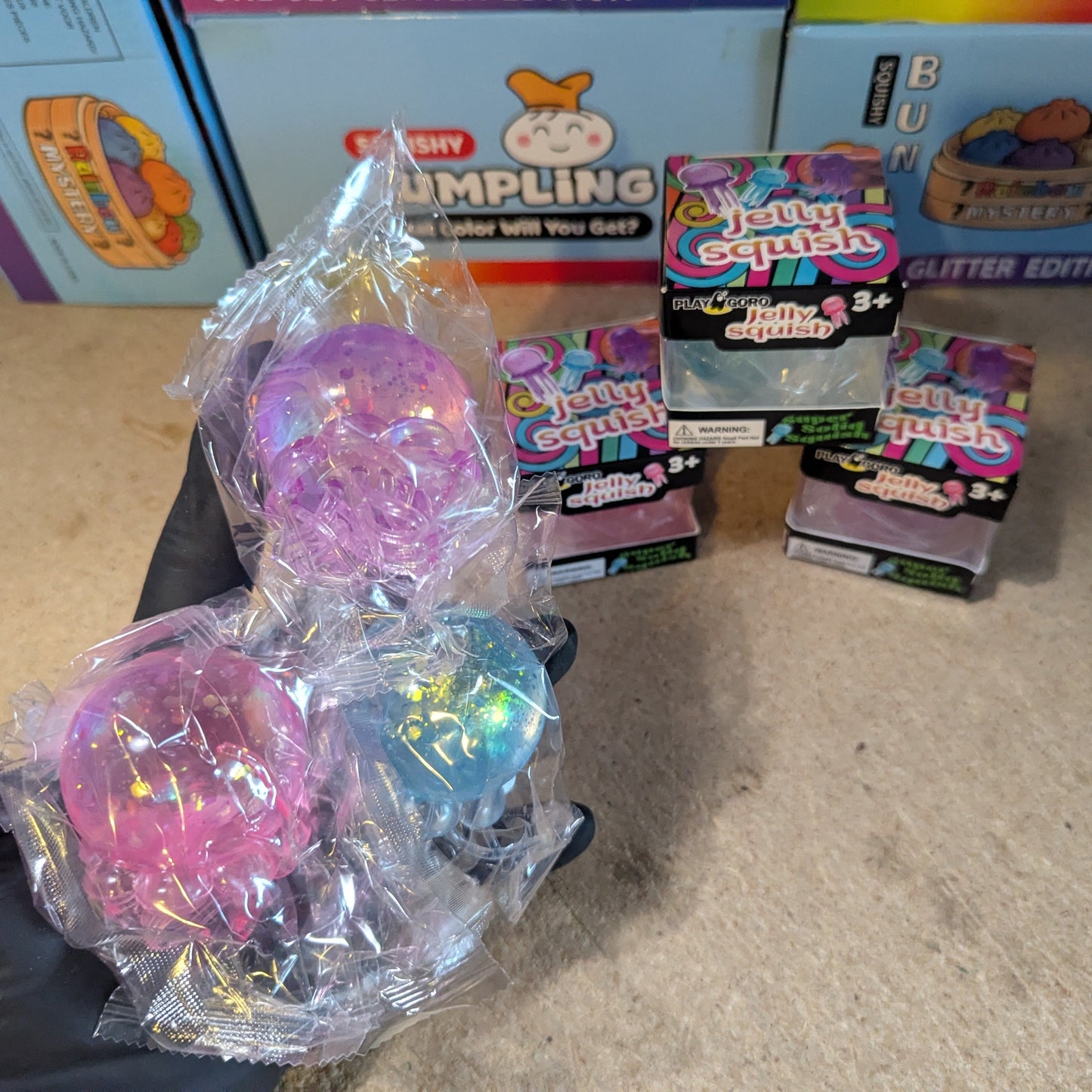 Set of three slow-rising jellyfish squish toys with tentacles from Ralphie's Funhouse, featuring colorful, translucent designs.