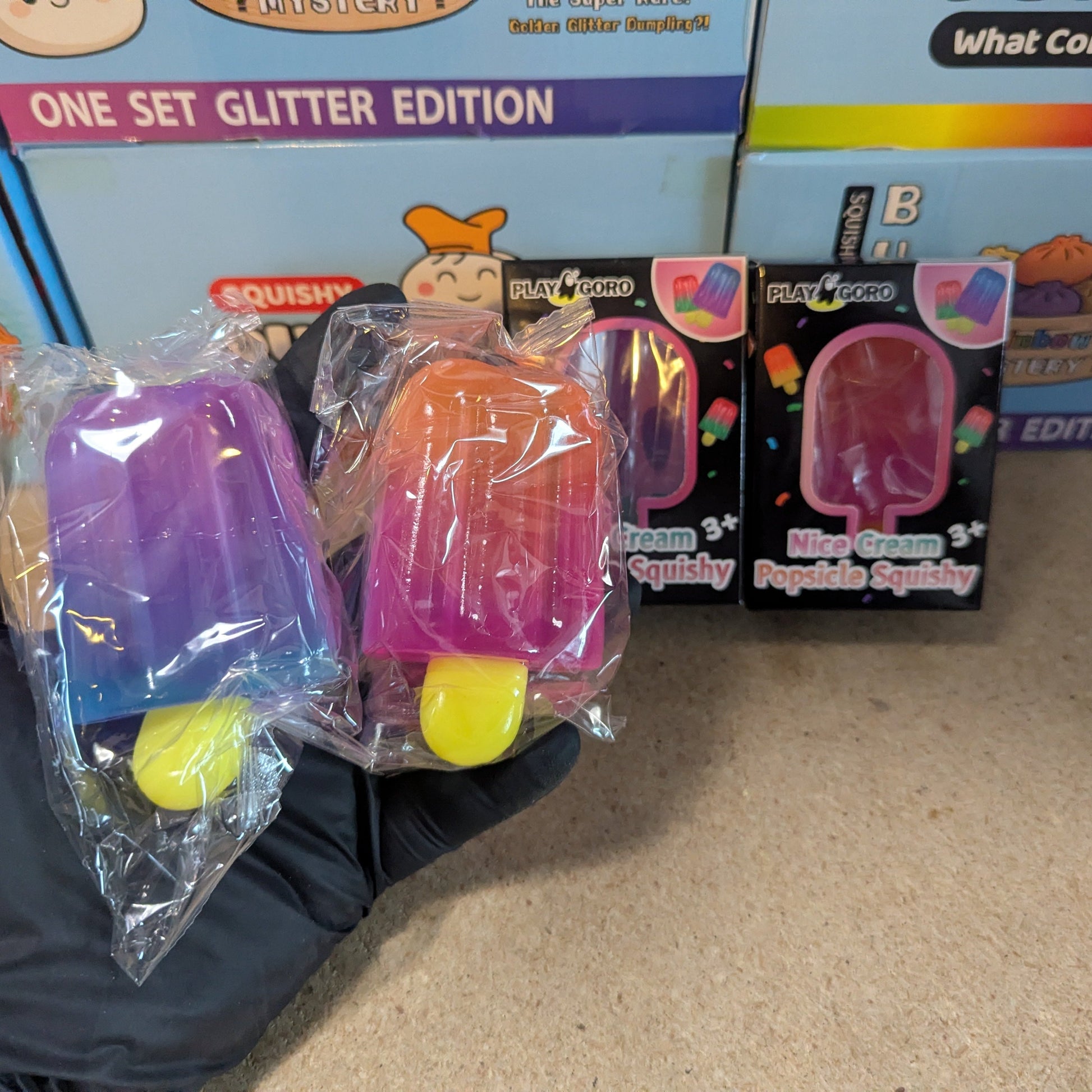Set of two Ralphie's Funhouse gelatin ice cream popsicles with colorful, squishy texture on a plain background.
