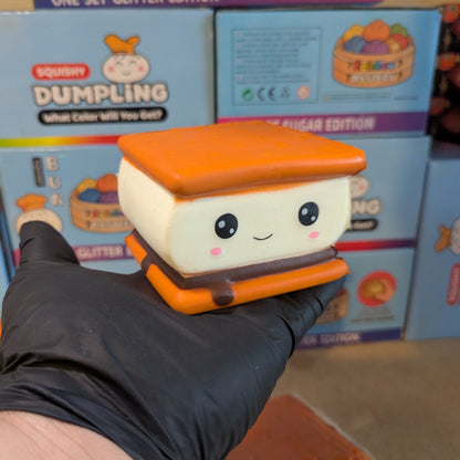 Ralphie's Funhouse Smilin' S'more squishy toy with a smiling face, featuring foam and marshmallow details for slow squish fun.