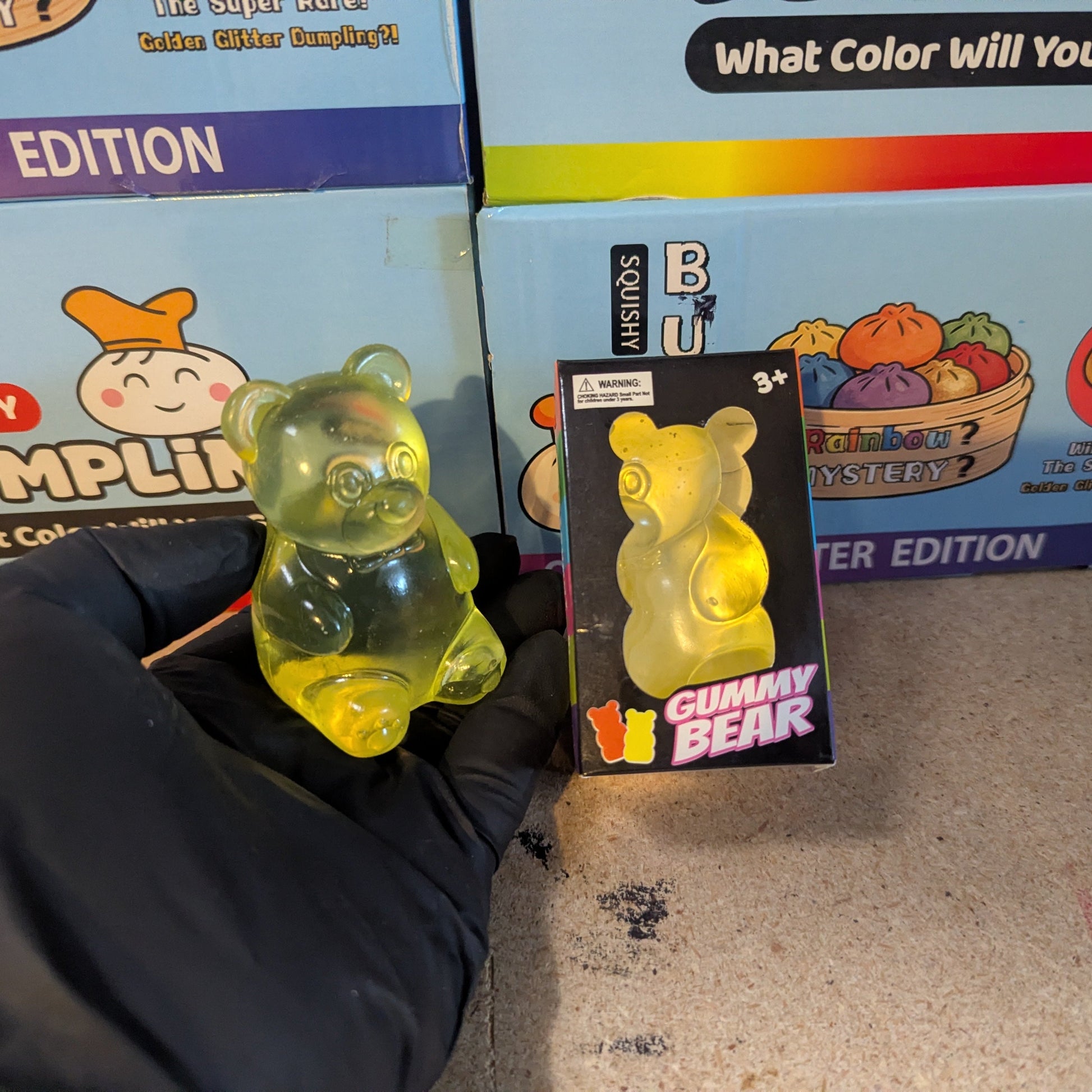 Yellow Gummy Bear Squish toy from Ralphie's Funhouse, slow-rising squish with soft, squeezable texture and bright yellow color.