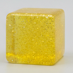 Yellow translucent glitter mini magic cube by Squeeze Toys, slow-rising squish toy with shiny glitter and compact cube shape