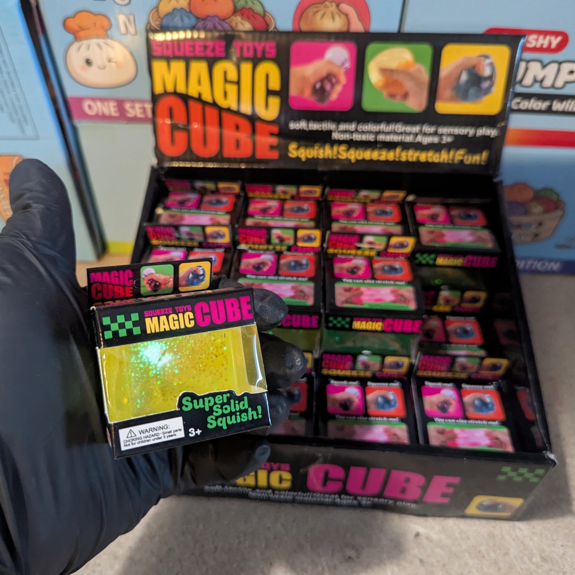 Yellow translucent glitter mini magic cube by Squeeze Toys, a slow-rising squish toy with sparkling glitter and soft, squishy texture.