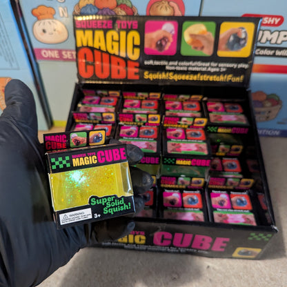 Yellow translucent glitter mini magic cube by Squeeze Toys, a slow-rising squish toy with sparkling glitter and soft, squishy texture.