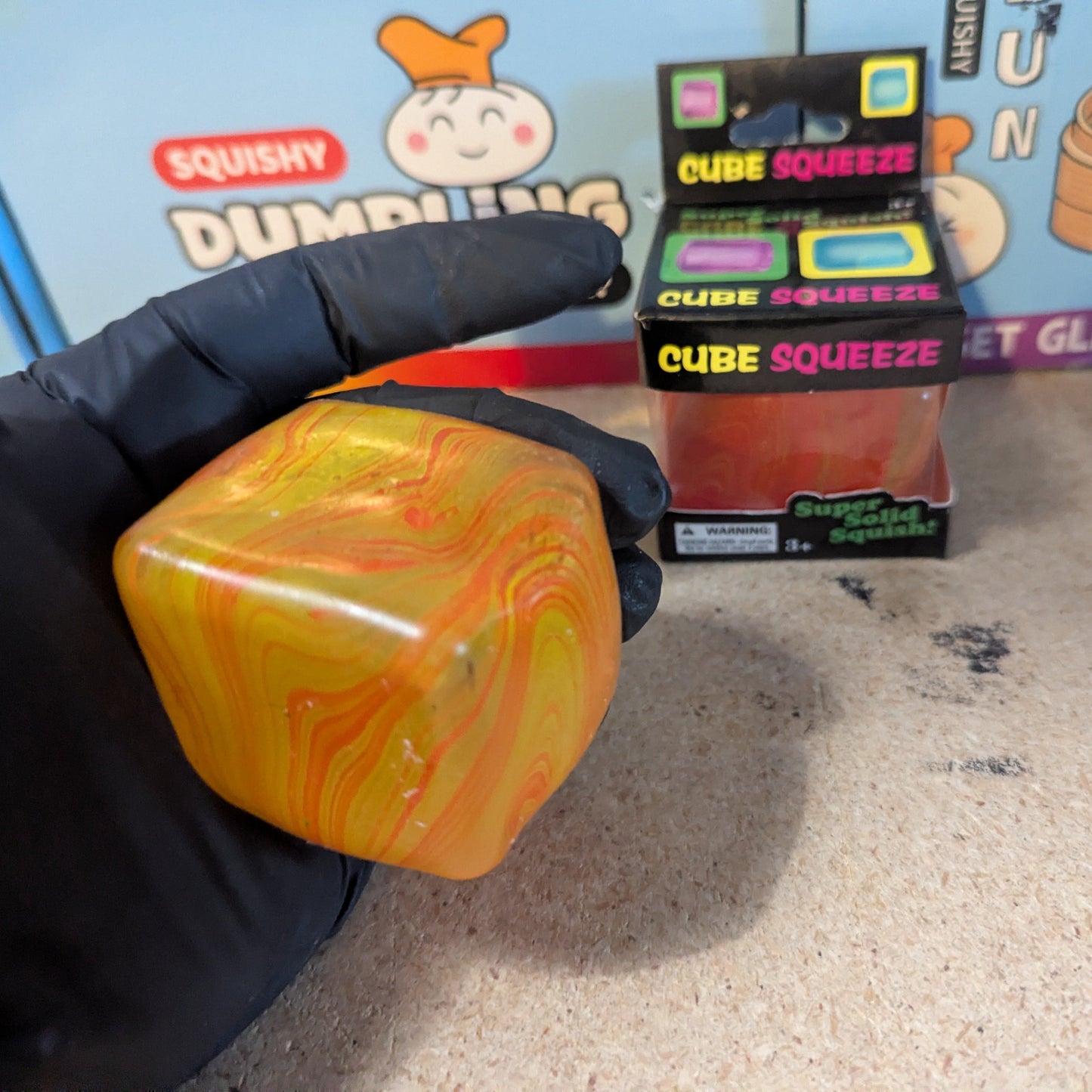 Yellow and orange swirl squeeze cube from Ralphie's Funhouse, a super slow-rising squishy stress relief toy.