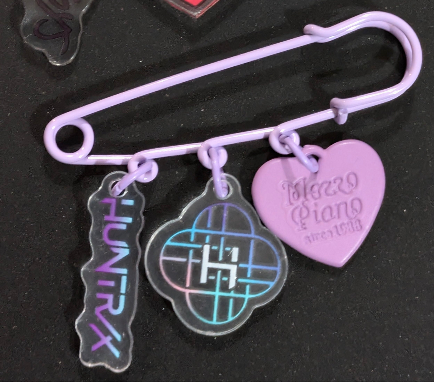K-POP DEMON HUNTERS safety pin charm featuring characters from Ralphie's Funhouse, detailed design on metal safety pin.