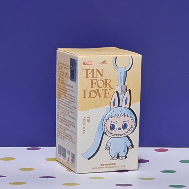 Sealed blind box featuring Ralphie's Funhouse Labubu Pin for Love, with colorful character design and letter options.