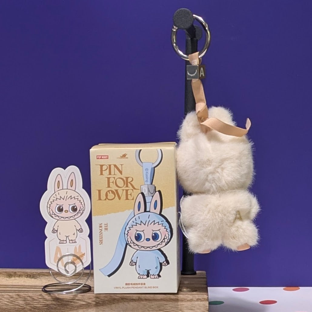 Sealed blind box featuring Ralphie's Funhouse Labubu Pin for Love, with customizable letter options, in unopened packaging.