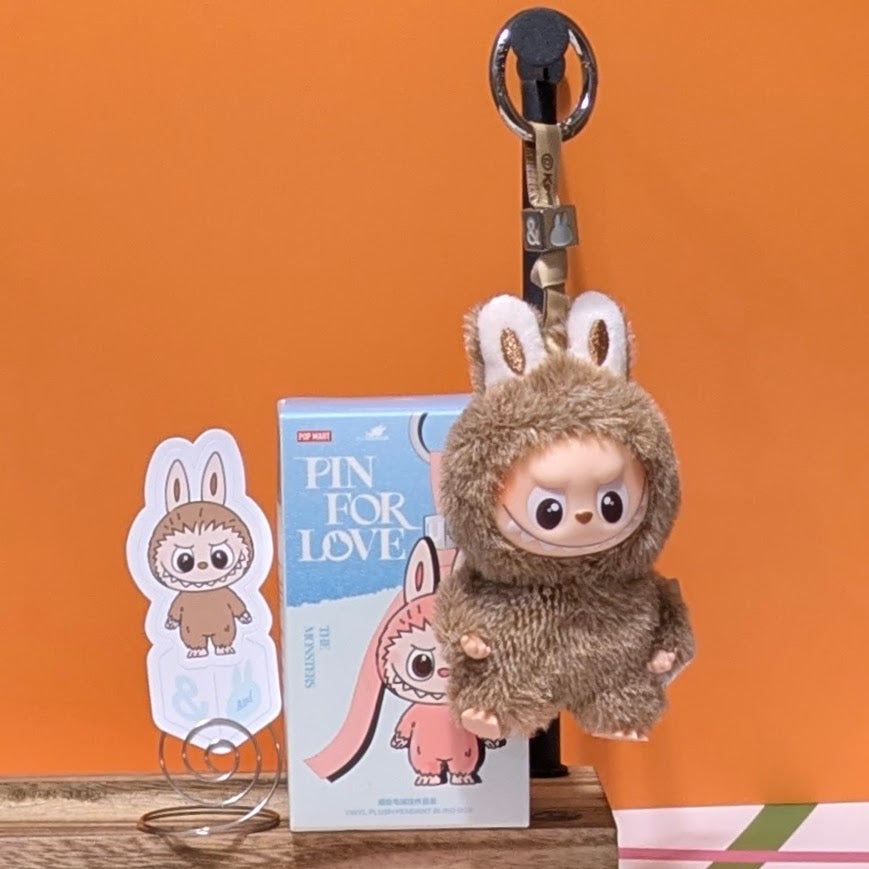 Sealed blind box featuring Ralphie's Funhouse Labubu Pin for Love with letter options, collectible accessory in vibrant design.