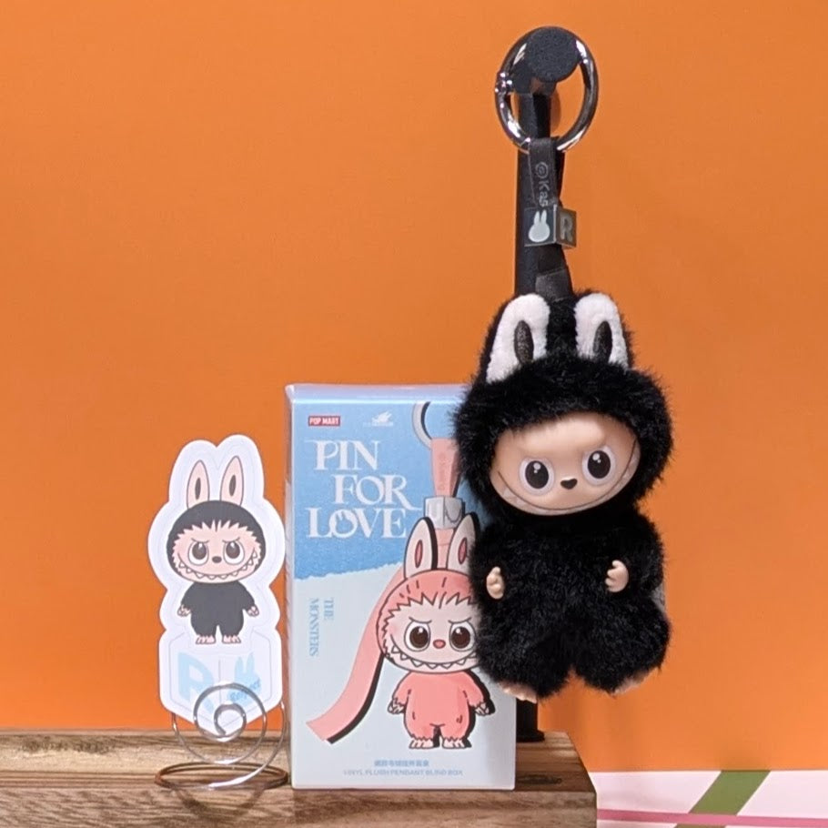 Sealed blind box with Ralphie's Funhouse Labubu Pin for Love, featuring colorful letter design from POPMART in stock.
