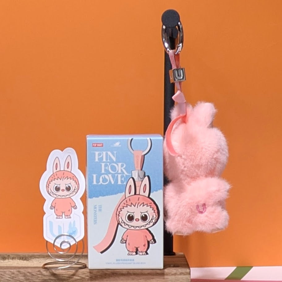 Sealed PopMart Labubu pin for love featuring letter options, from Ralphie's Funhouse, displayed in its packaging.