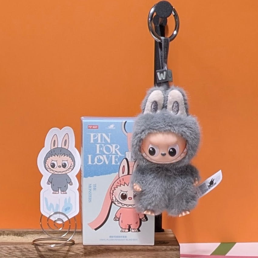 Sealed blind box featuring Ralphie's Funhouse Labubu Pin for Love, with colorful character design and letter options inside.