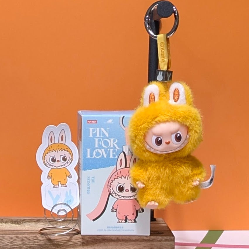 Sealed blind box showing Ralphie's Funhouse Labubu pin for love with customizable letter options, in stock and ready to open.