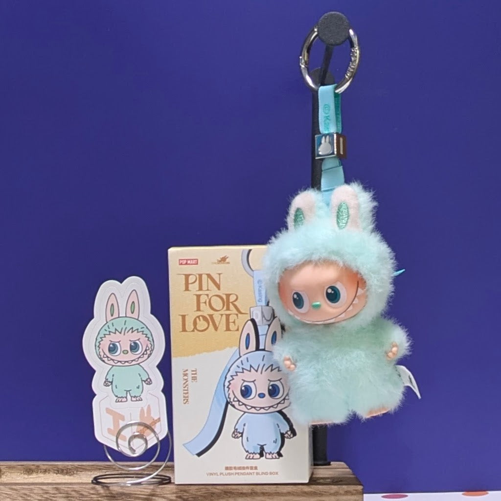 Sealed blind box featuring Ralphie's Funhouse Labubu Pin for Love, with colorful design and letter options, in stock.