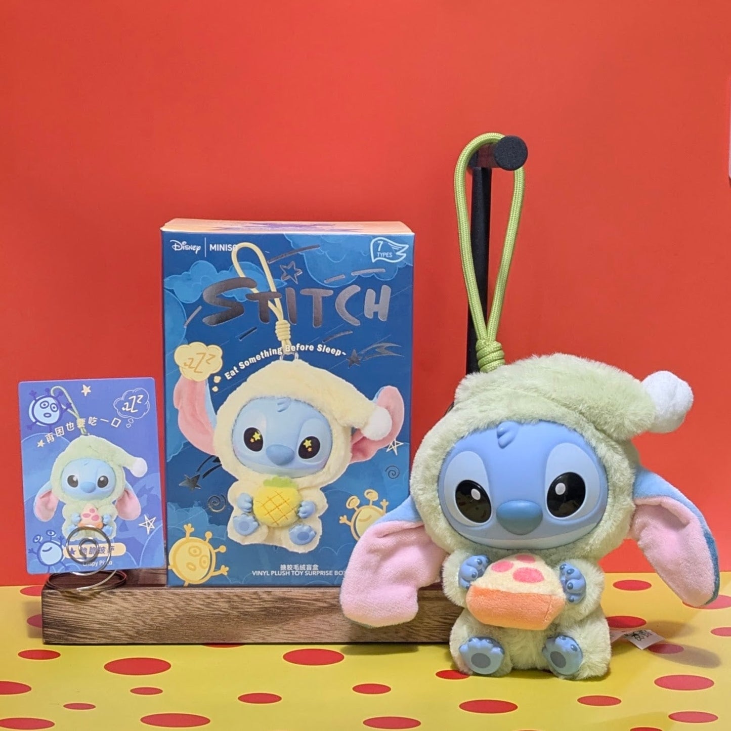 Sealed blind box featuring a Stitch plush keychain from Miniso, with Stitch eating something before sleep, by Ralphie's Funhouse.