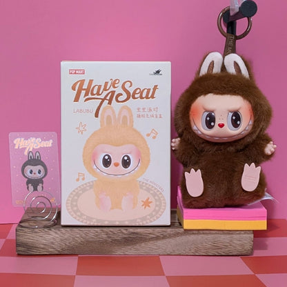 Sealed Popmart Have a Seat Labubu vinyl plush blind box from Ralphie's Funhouse, featuring colorful plush character inside.