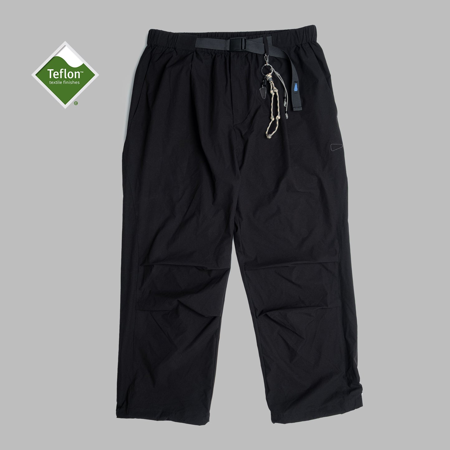 Black pleated field pants by Shuren Projects made from Teflon™ polyester, showcasing their durable, stylish design.
