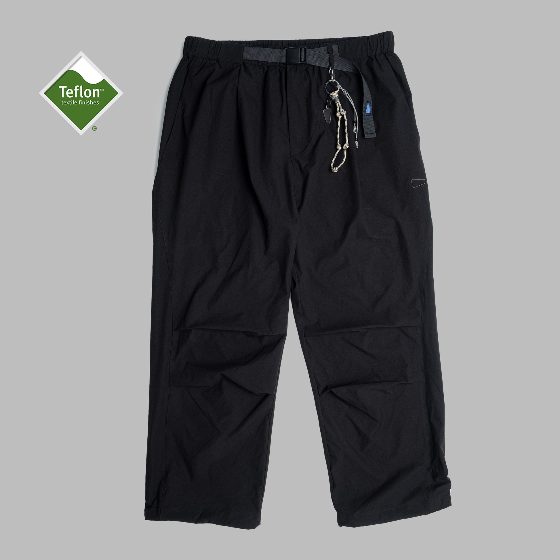 Black pleated field pants by Shuren Projects made from Teflon™ polyester, showcasing their durable, stylish design.