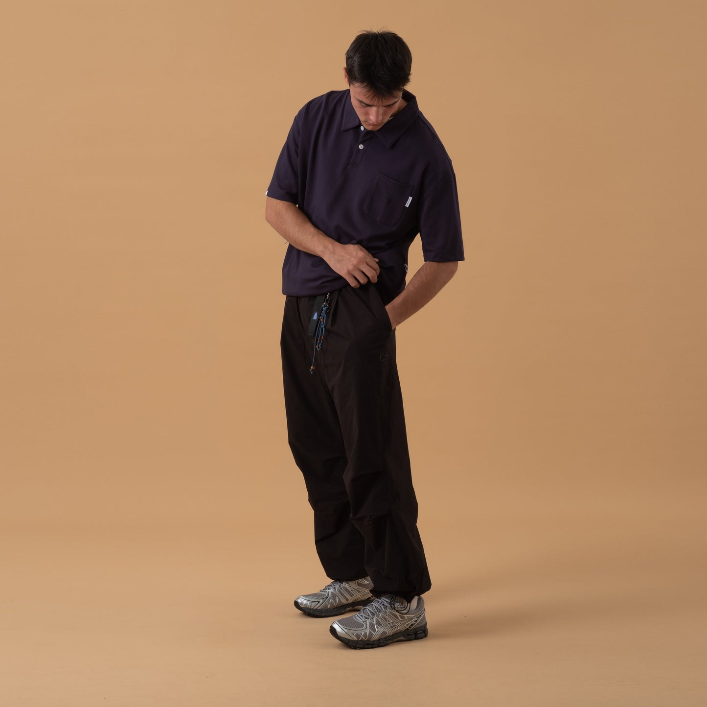 Black Shuren Projects pleated field pants made of Teflon™ polyester, showcasing their durable, stylish bottom design.