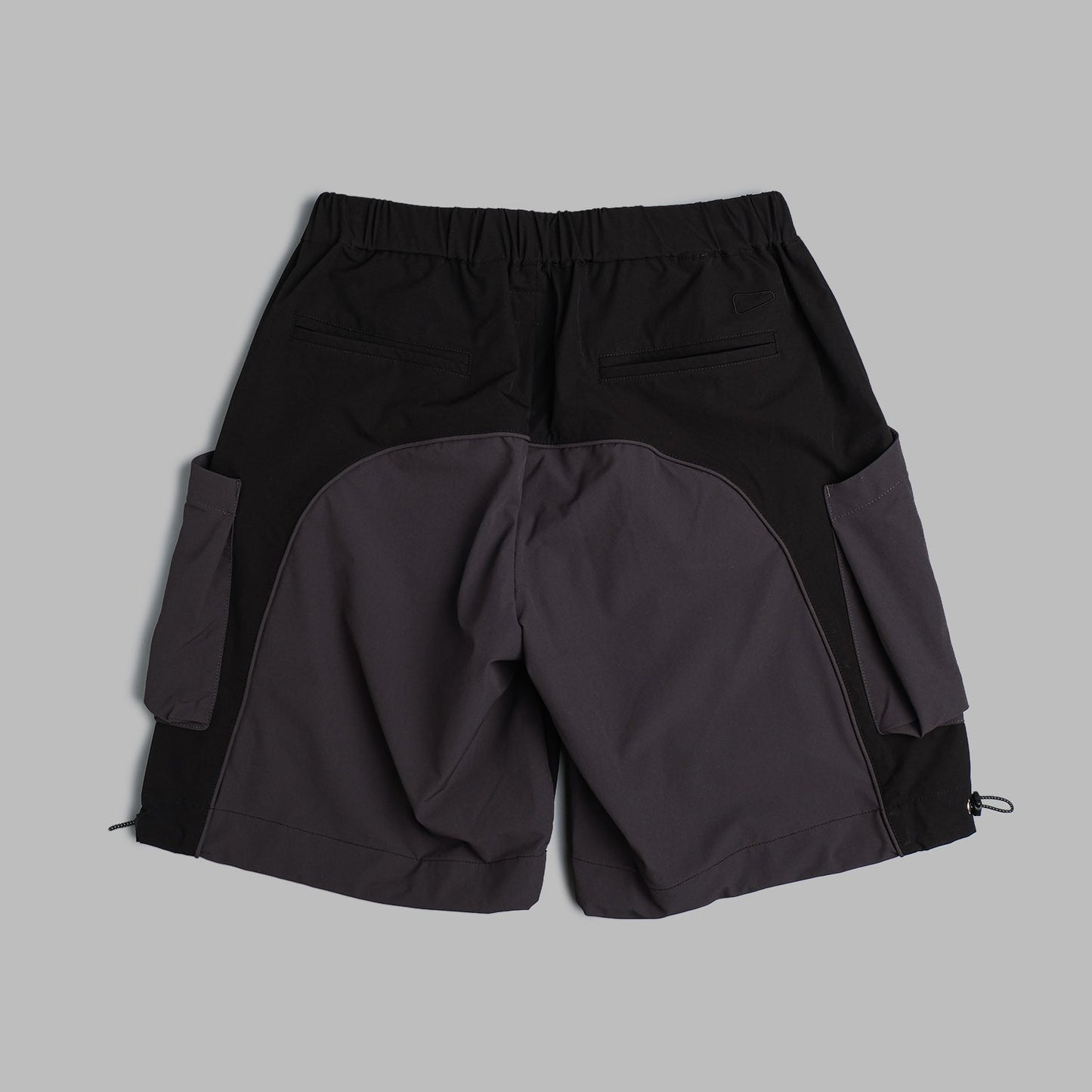 Black 2-tone nylon camping shorts by Shuren Projects, featuring a lightweight, durable design for outdoor adventures.