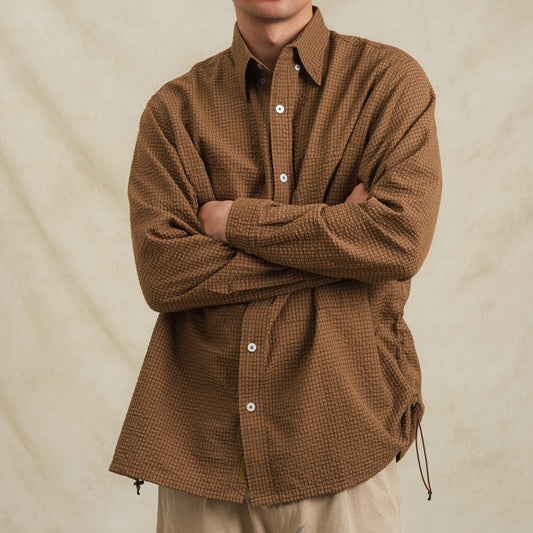 Brown checkered sidepull shirt made of seersucker cotton by Shuren Projects, showing the front view of the casual button-up shirt.