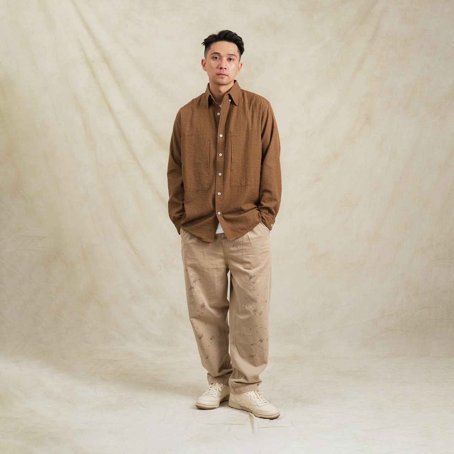 Brown checkered sidepull shirt made from seersucker cotton by Shuren Projects, displayed on a neutral background.