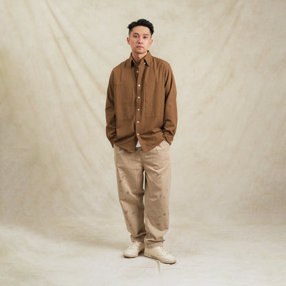 Brown checkered sidepull shirt made from seersucker cotton by Shuren Projects, displayed on a neutral background.