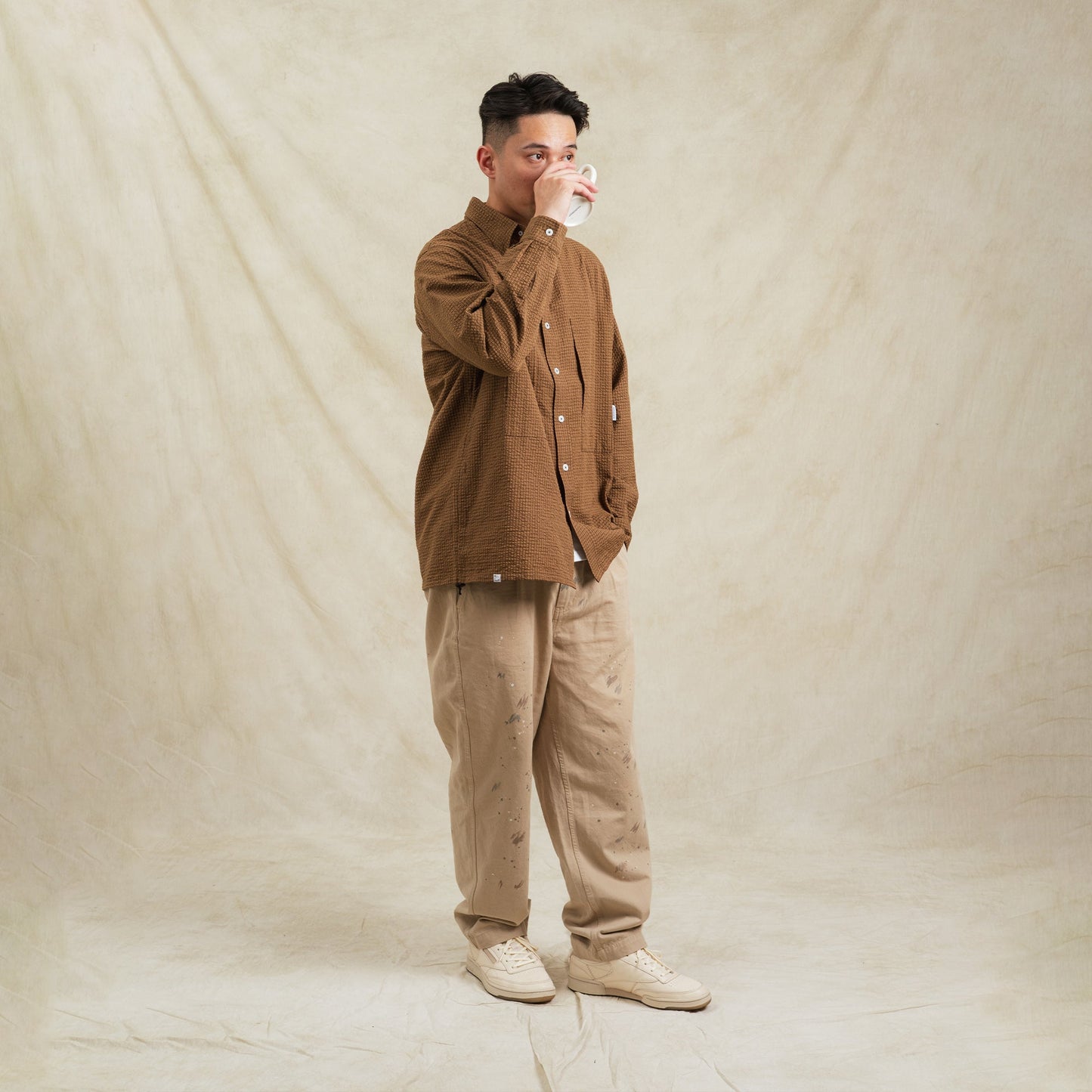 Brown checkered Seersucker cotton sidepull shirt by Shuren Projects, featuring a casual, stylish design and classic pattern.