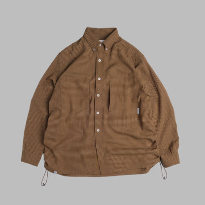 Brown checkered sidepull shirt made of seersucker cotton by Shuren Projects, shown in a close-up of the fabric and design.