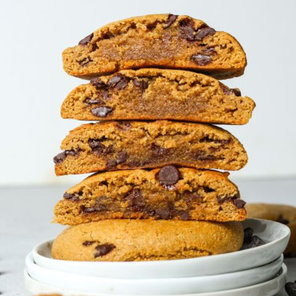 Sweet Addison's protein cookie, showing a close-up of a delicious, freshly baked cookie with chocolate chips on a white plate.