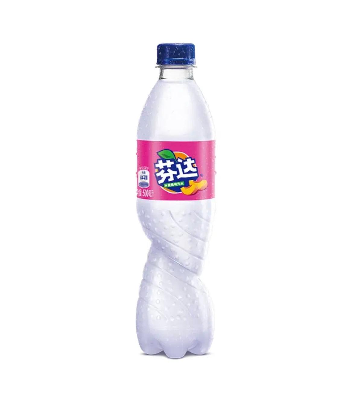 Fanta White Peach beverage in a clear plastic bottle with a colorful label, showcasing the peach flavor and branding.