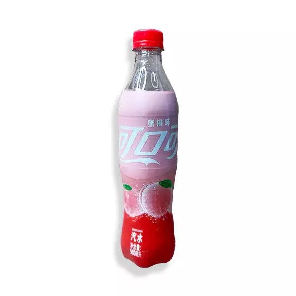 Peach Coca-Cola beverage in a glass bottle with a red label and peach flavor branding from Sweet Palace.