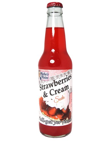 Sweet Palace Melba's Fixins Soda bottle with butterscotch candy, showcasing the colorful beverage and candy inside.