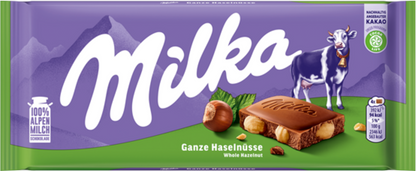 Sweet Palace Milka chocolates, creamy Alpine milk candy bars with purple packaging and Milka branding, on a white background.