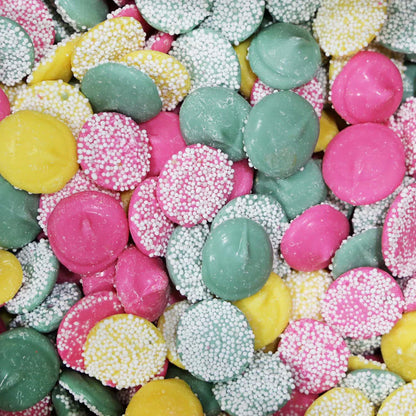 Colorful Sweet Palace nonpareils candy in a clear jar, showing tiny rainbow-colored sugar beads for decorating treats.