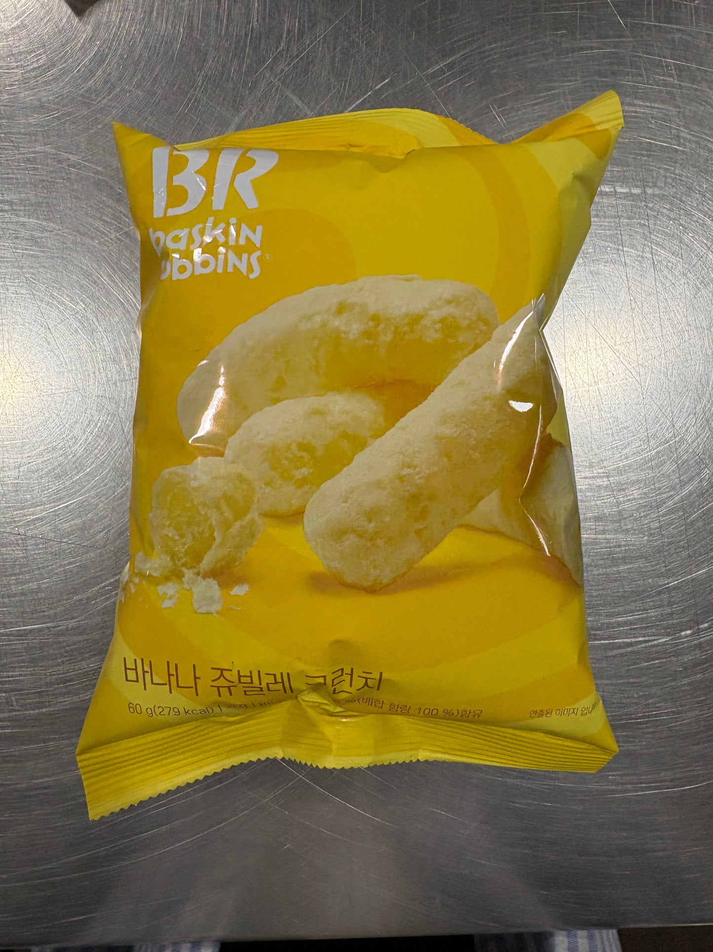 Sweet Palace Banana Jubilee Crunch Baskin Robbins Puffs chips in a bright, colorful bag showing the banana-flavored snack.