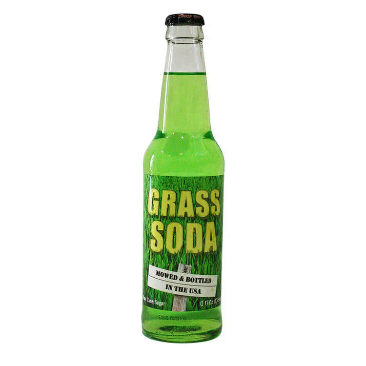 Lester's Fixins Grass Soda by Sweet Palace in a clear glass bottle with green label, showcasing vibrant soda inside.