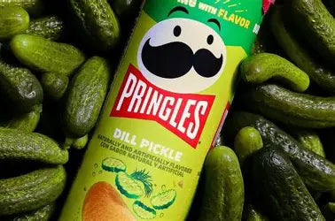 Pringles Dill Pickle flavored potato chips in a colorful can, showing the snack's vibrant green and pickle image on the packaging.