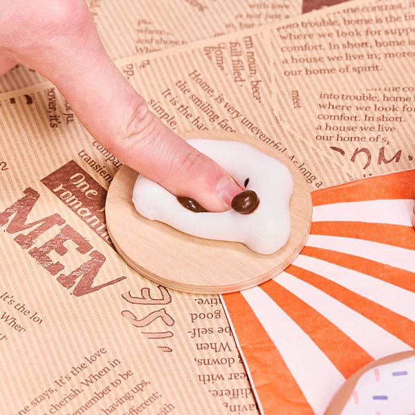 SqueezeSquad Taba Deluxe silicone squishy fidget toy in cloud dumpling shape, soft and squeezable for stress relief.