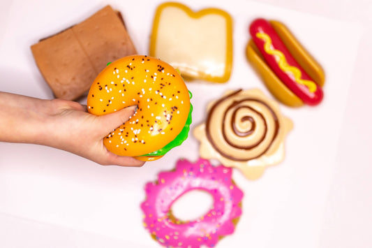 Colorful MushMeez Taba Squishies food assortment including donuts and snacks from The Autism Store, soft and squishy toys.