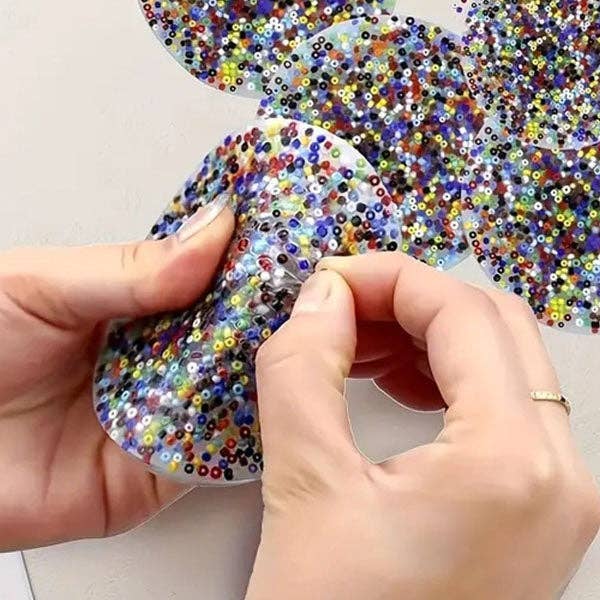 Glow-in-the-dark PocketPick Therapy Tool by The Autism Store, a compact fidget toy for tactile sensory stimulation.