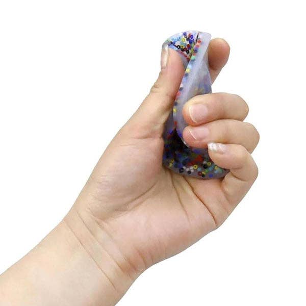 Glow-in-the-dark PocketPick fidget therapy tool by The Autism Store, featuring colorful, textured surfaces for sensory engagement.