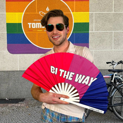 Hand fan from The Gay Fan Club featuring the Bi the Way design, with colorful graphics and a lightweight, portable structure.