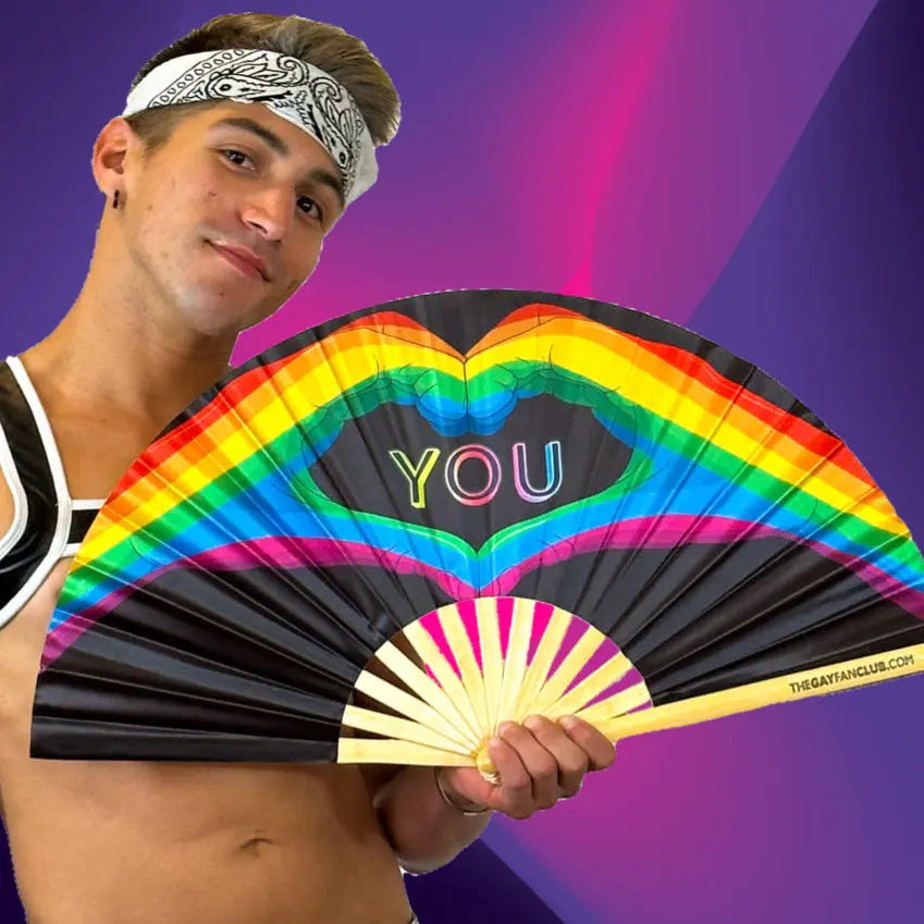 Hand fan from The Gay Fan Club featuring a "Love You" design, perfect for expressing affection and staying cool.