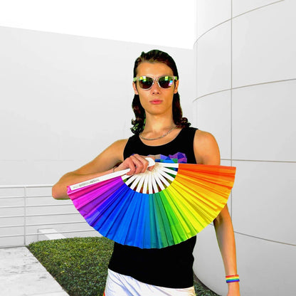 Colorful Over The Rainbow hand fan by The Gay Fan Club featuring vibrant rainbow stripes and decorative fan design.