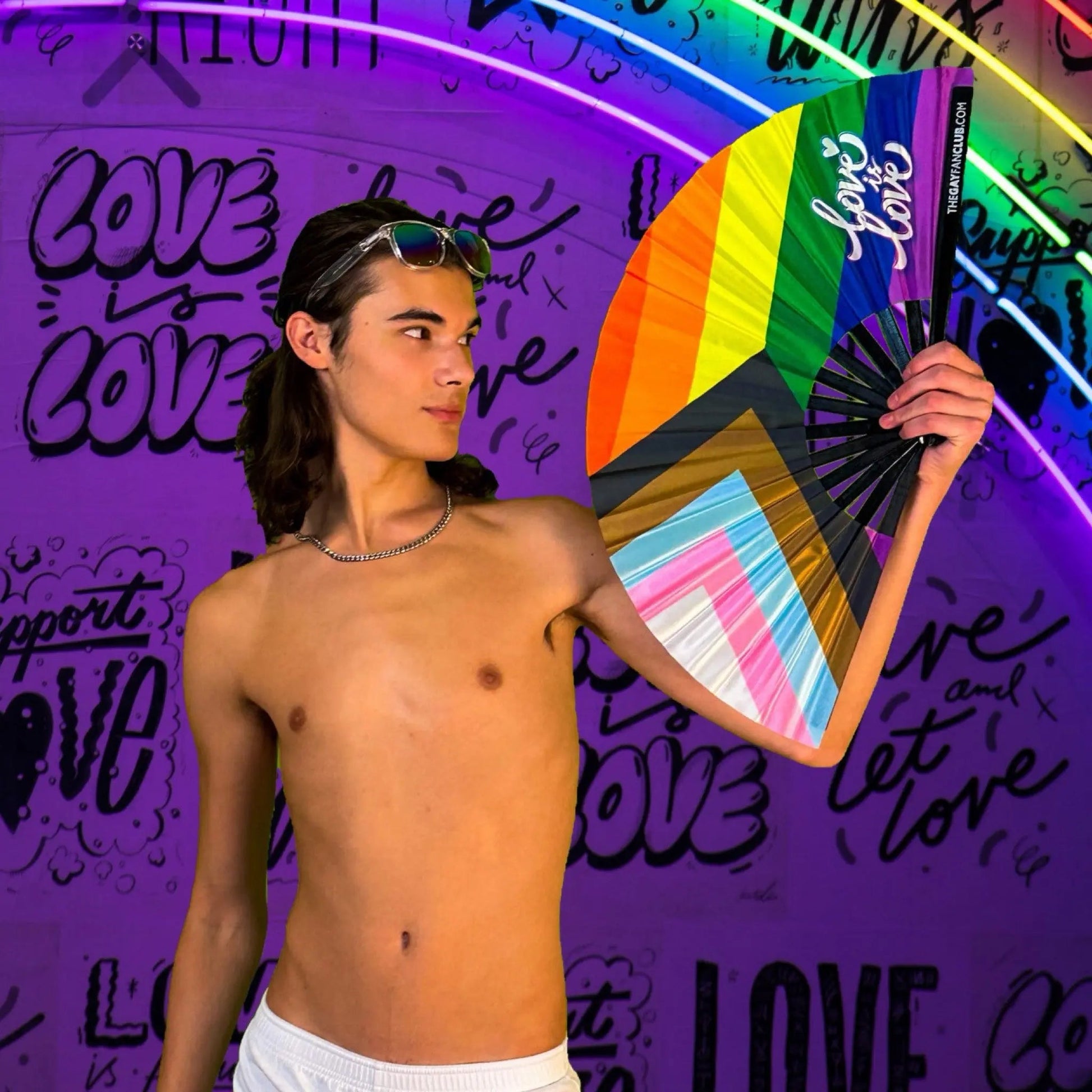 Hand fan featuring the Pride rainbow flag by The Gay Fan Club, showcasing vibrant rainbow colors on a lightweight fan.
