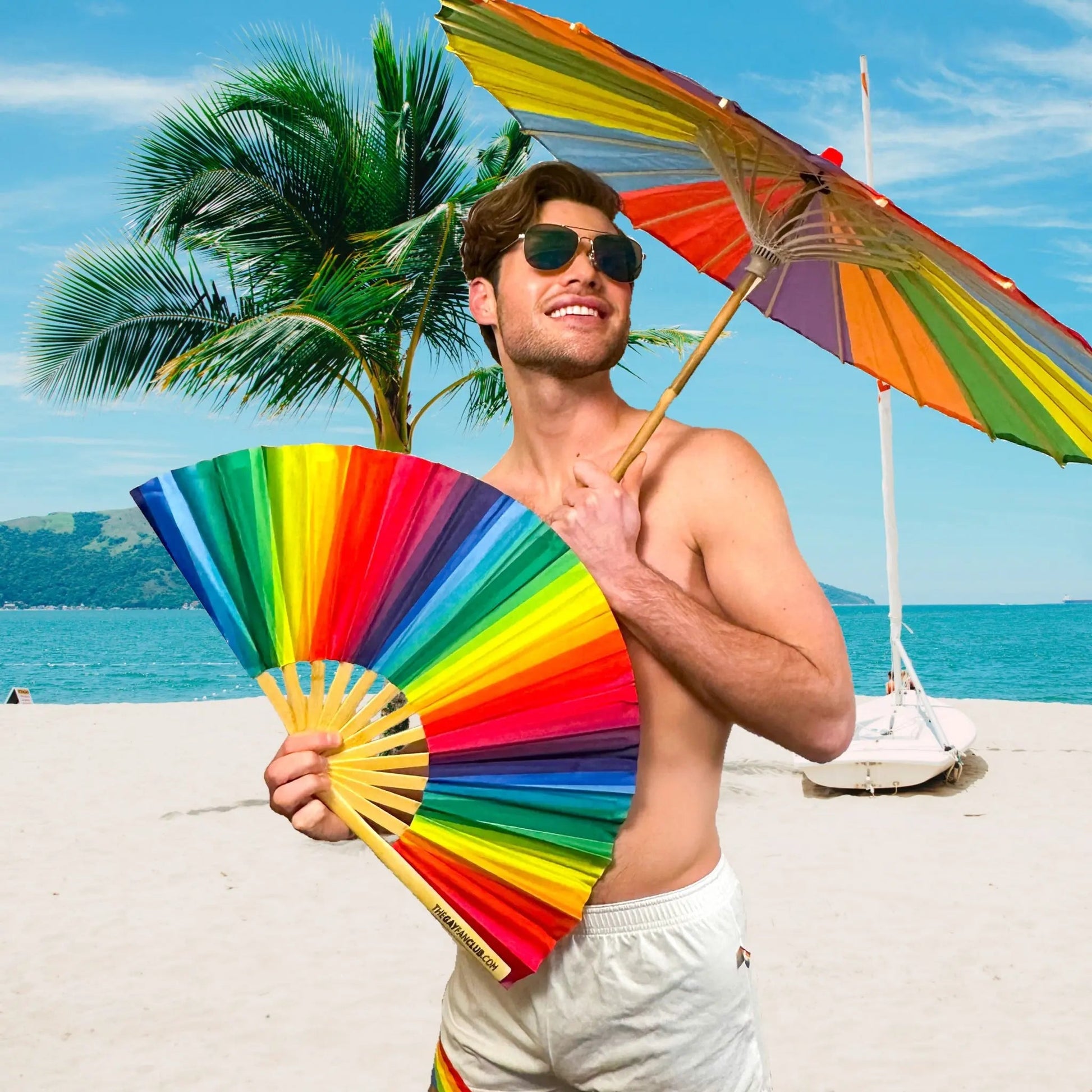 Rainbow folding hand fan by The Gay Fan Club with vibrant rainbow colors and a compact, foldable design.