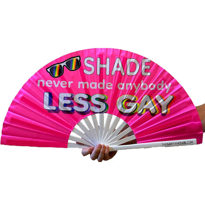 Hand fan from The Gay Fan Club with "Shade Never Made Anybody Less Gay" slogan, featuring vibrant colors and a foldable design.